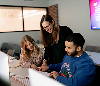 Three people in a classroom