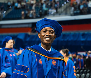 UF graduate in doctoral regalia at commencement